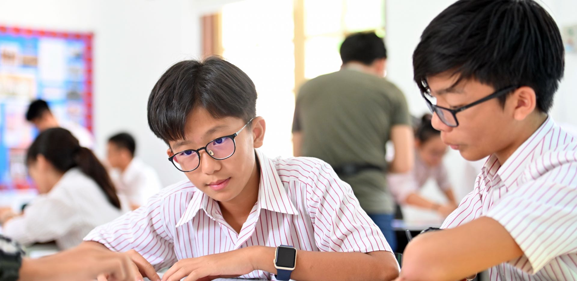 Senior pupils at KTJ applying math calcualtions on a whiteboard